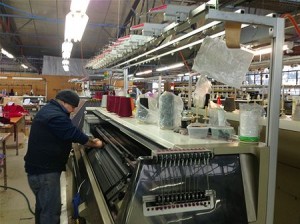 A machine operator at the A and B Knitwear, Merino Gold factory in Brunswick, Victoria Image credit: abc.net.au