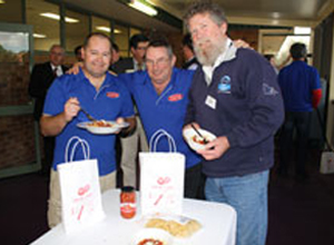 Delicious local flavour: Foods division president Tom Hale (right) enjoys the pasta meal with fellow AMWU men, GV Co-op members Chris Lloyd (centre) and Jason Hefford. Image credit: AMWU