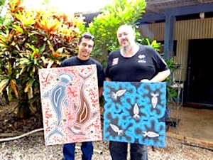 New AMWU organiser Russell Davey (left) shows WA State Secretary Steve McCartney some of his paintings.