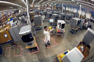 A quality control technician examines a part produced by a Stratasys 3D printer. Image credit: flickr.com  User: fourthdaypr