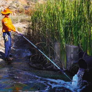 Mount Isa Mines Environmental Adviser Jono Sanders samples stormwater runoff on the lease Image credit: http://www.glencore.com/assets/media/image-library/ttlgp0001369-1294.jpg