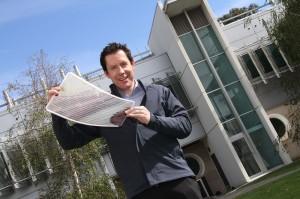 Dr Scott Watkins holding a sheet of flexible solar cells. Image via CSIRO