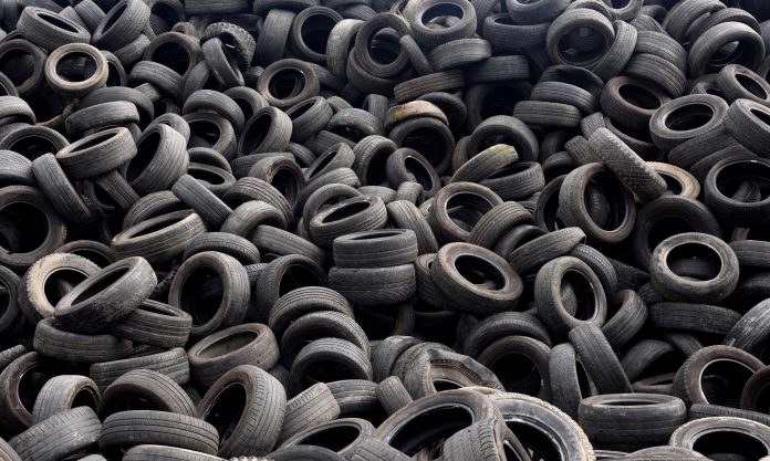 woman working on tire recycling