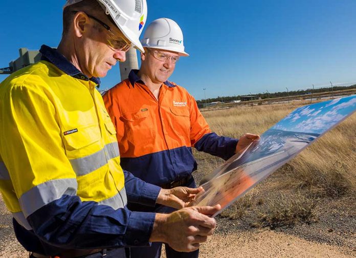 CS Energy CEO Andrew Bills shows Senex Energy CEO Ian Davies an artist's impression of the hydrogen demonstration plant at the project site.